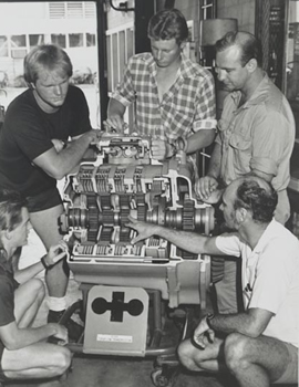 Students viewing the working of a car engine in the 1990s
