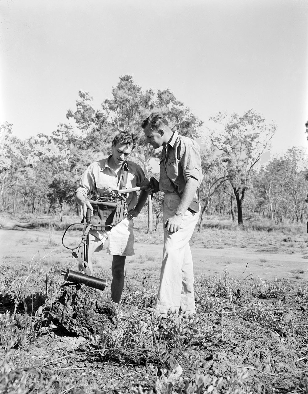Geophysicist Don Dyson (left) and Geologist Hector Ward use a Geiger counter to examine a mineral outcrop in a belt of uranium bear (1955) National Archives of Australia: A1200, L19458.