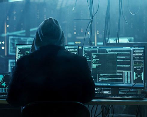 Hacker working on computers